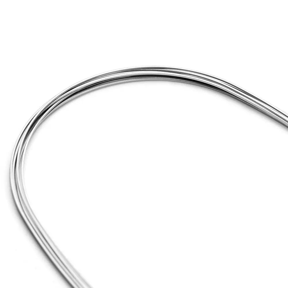 Archwire NiTi Super Elastic Natural Rectangular 0.018 x 0.025 Lower 10pcs/Pack - Curved, shiny dental orthodontic wire made of nickel titanium, designed for lower teeth alignment. Natural form saves time during treatment. Close-up view showing the wire's smooth surface and precise curvature.