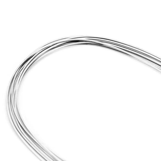 Archwire Stainless Steel Natural Form Rectangular 0.018 x 0.022 Upper 10pcs/Pack: Coiled silver-colored stainless steel wire with natural curvature for dental orthodontic use, showcasing flexibility and strength for effective tooth alignment and space closure