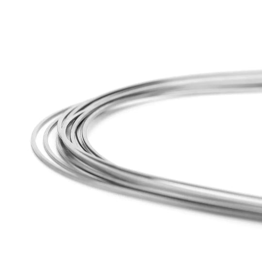 Archwire Stainless Steel Oval Form Rectangular 0.017 x 0.022 Upper 10pcs/Pack shown as curved, shiny metal wires in close-up view. The wires appear flexible and smooth, demonstrating the product's high-quality finish and oval form designed for dental orthodontic use.