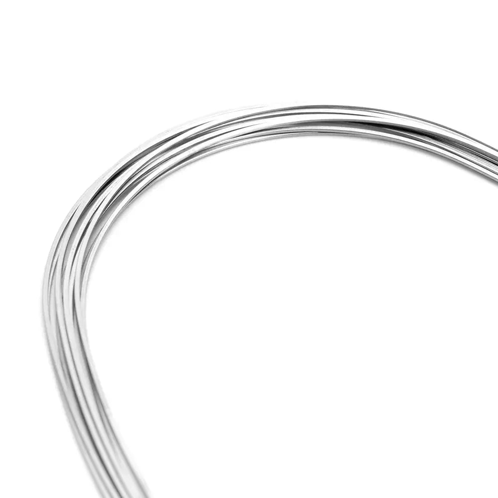 Archwire Stainless Steel Oval Form Rectangular 0.018 x 0.025 Upper 10pcs/Pack - Close-up of shiny, curved stainless steel orthodontic wires with smooth surface and oval form, demonstrating flexibility and strength for dental applications.