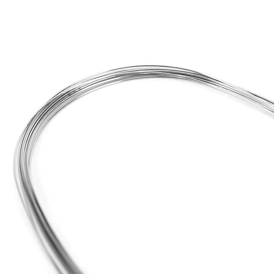 Archwire Stainless Steel Oval Form Round 0.016 Lower 10pcs/Pack: Close-up of curved, shiny stainless steel dental orthodontic wire against white background, showcasing its flexibility and oval form for lower teeth alignment and space closure.