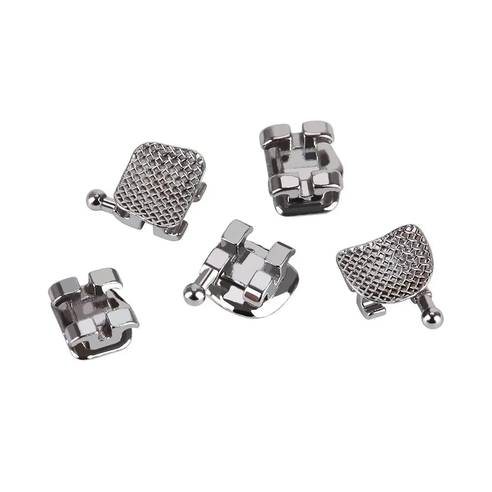 Dental Metal Brackets Standard Edgewise Slot .022 Hooks on 345 20pcs/Pack: Close-up of five silver orthodontic brackets with textured mesh bases and smooth edges, showcasing their compact design and precise engineering for accurate teeth alignment.