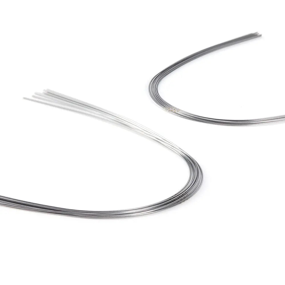 Archwire NiTi Super Elastic Ovoid Form Round 0.014 Upper 10pcs/Pack: Curved dental archwires in silver and white colors, showcasing the flexibility and shape of NiTi super elastic orthodontic wires used for teeth alignment in dental treatments.