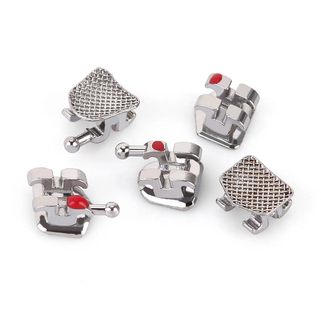 Dental Mini Metal Brackets For Braces Full Size 20pcs/Pack: Close-up of five silver orthodontic brackets with mesh bases and red color-coded indicators, showcasing their compact design and precise engineering for comfortable, efficient teeth alignment.