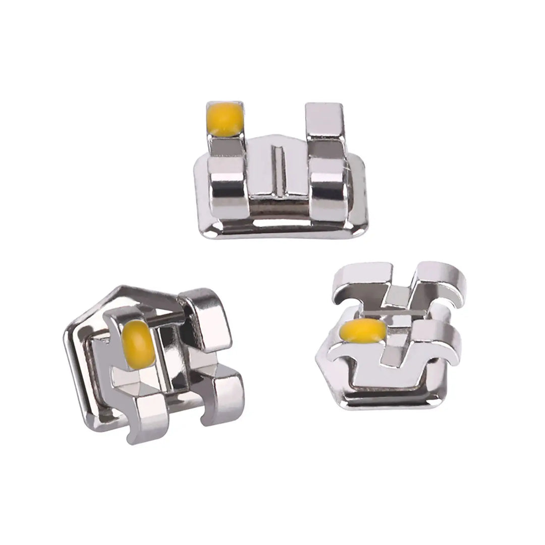 Dental Metal Brackets Mini Roth Slot .022 Hooks on 345 20pcs/Pack: Close-up view of three silver orthodontic brackets with yellow color-coded markers. Each bracket features a rectangular slot and precise design for accurate placement and comfortable wear in orthodontic treatments.