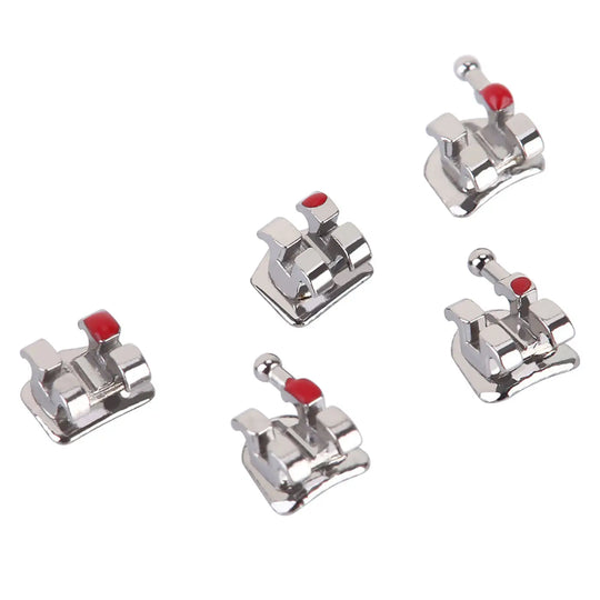 Dental Metal Brackets Mini Roth Slot .018 Hooks on 345 20pcs/Pack - Close-up of five silver orthodontic brackets with red color-coded markers, showcasing their rhomboid shape and hooks for precise teeth alignment and wire attachment in orthodontic treatments.