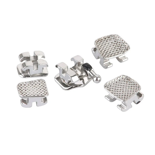 Dental Metal Brackets Mini MBT Slot .022 Hooks on 3 20pcs/Pack: Close-up of silver orthodontic brackets with textured surfaces and hooks, showcasing various designs including mesh-patterned and smooth finishes, arranged on a white background to display product details.